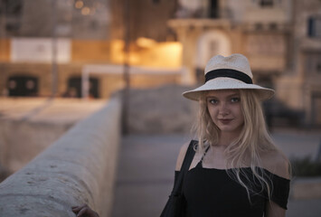 portrait of young female tourist at night in the street