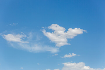 Naklejka na ściany i meble Beautiful white puffy clouds in a blue sky. A pretty cloudscape. Fresh, airy light and clean. Clouds above the Sonoran Desert in Tucson, Arizona, USA.