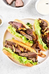 Sandwiches with beef and caramelized onion