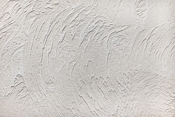 Pattern of light beige decorative and textured plaster. Construction and finishing materials for repairs of walls in apartments, houses and offices. Background and texture for design and decoration.