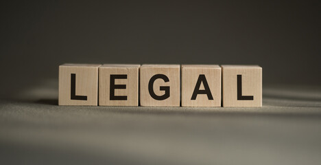 legal text on wood blocks on a wooden table