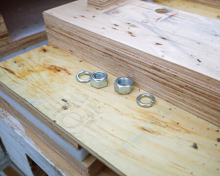 lock nuts and washers on a wooden pallet