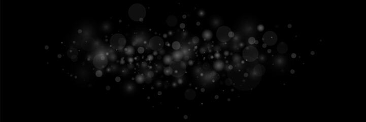 The dust is white. White sparks and stars shine with a special light. Vector sparkles on a black background. Christmas light effect. Shiny magical dust particles.