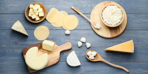 Fototapeta premium Different dairy products on blue wooden background, top view