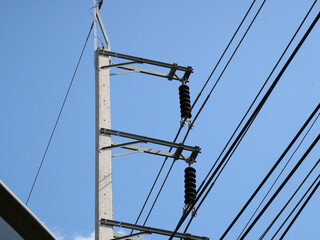 Electric pole with blue sky coluds background.