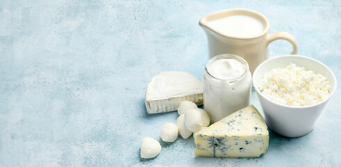 Fototapeta na wymiar Different dairy products on light blue background with space for text