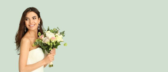 Beautiful young bride with bouquet of flowers on light green background with space for text