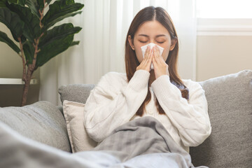 Sick, coronavirus or covid-19, attractive asian young woman, girl have a fever, flu and hand in use...