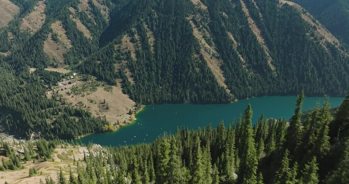 Kolsai Lake, Kazakhstan. Deep mountain lake Lake Kaindy sunken forest landmark in asia. Beautiful mountain nature landscape. Blue lake Kolsai top view. Panoramic view of the nature reserve. 