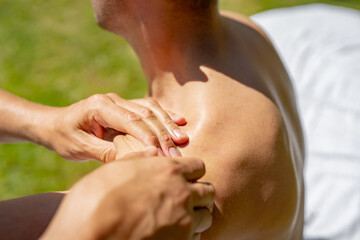professional shoulder massage large masseur hands