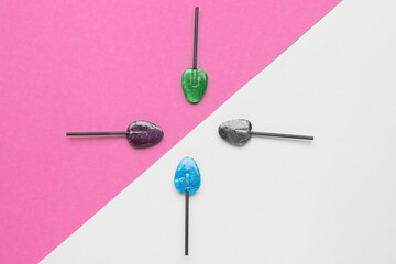 Sweet lollipops on pink and lilac background