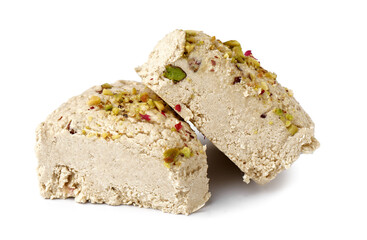 Pieces of tasty Tahini halva with pistachios on white background