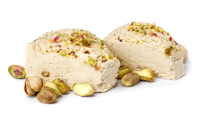 Pieces of tasty Tahini halva with pistachios on white background