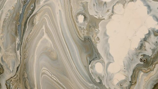 Beige and brown pattern of liquid macro colors slowly flowing on surface. Abstract background. 
