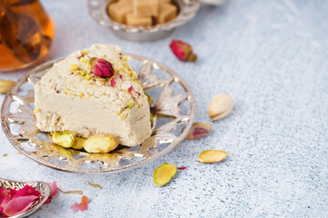 Plate with piece of tasty Tahini halva on light background