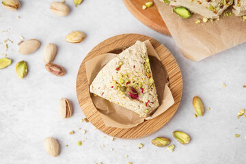 Plate with piece of tasty Tahini halva on light background