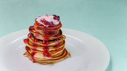 Fritters with berry jam on a plate - obrazy, fototapety, plakaty