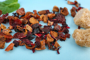 Dried fruit tea on blue background, closeup
