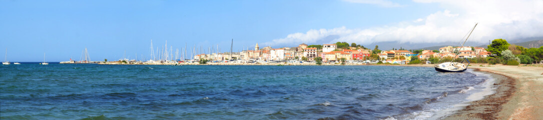 Fototapeta na wymiar panoramic view of the beach, the marina and the famous seaside resort of Saint Florent, capital of the Nebbio region of the island of Corsica, nicknamed the Island of Beauty