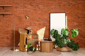 Interior of living room with armchair, table and Monstera houseplant