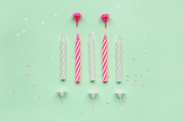 Birthday candles on green background