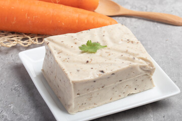 black sesame tofu grains tofu in a white plate