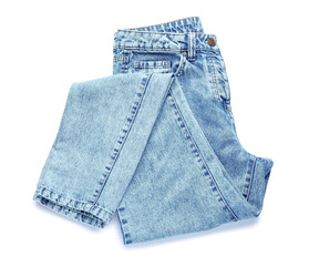 Folded jeans on white background