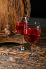 Wooden barrel with glasses of wine on table
