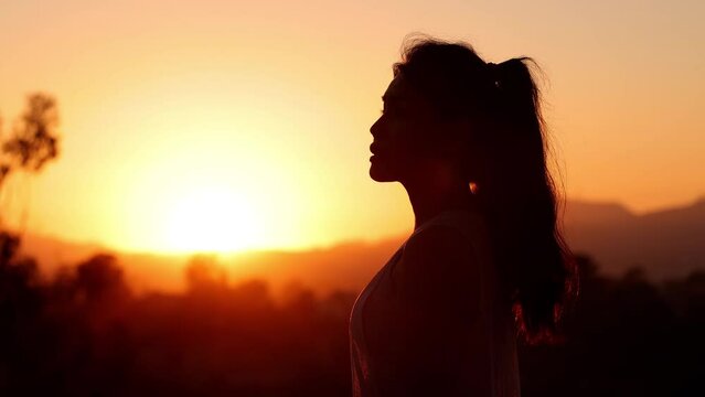 Asian woman enjoying the sunset after her workout in the park. Los Angeles California.