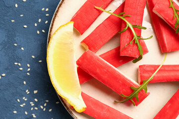 Plate with tasty crab sticks on blue background, closeup © Pixel-Shot