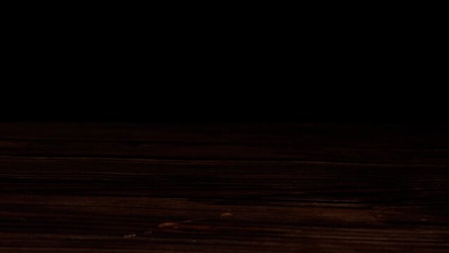 sliding a whisky glass on a counter top -black background (4k - slow motion)[ high quality colors]