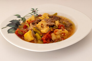 Meat stew with potatoes in a white plate