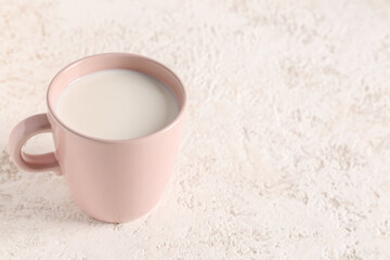 Cup with fresh milk on white background