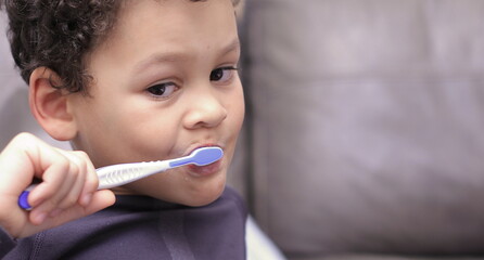 little boy brushing his teeth with an electric tooth brush stock image with background with people stock photo  
