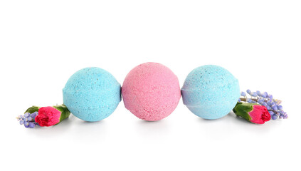 Bath bombs with flowers on white background