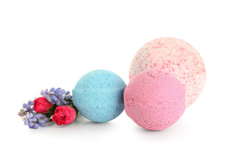 Bath bombs with flowers on white background