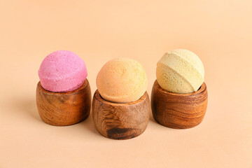 Wooden stands with bath bombs on beige background