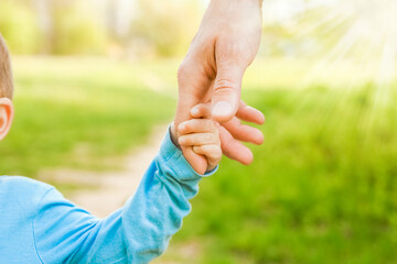 the parent holding the child's hand with a happy background