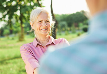 woman man senior couple happy retirement together elderly freedom carefree dancing portrait active vitality bonding park outdoor fun love