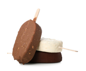 Different chocolate covered ice cream on stick against white background