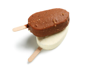 Different chocolate covered ice cream on stick against white background
