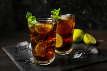 Glasses of tasty Cuba Libre cocktail on table