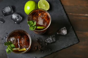 Glasses of tasty Cuba Libre cocktail on table