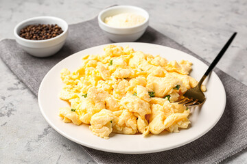 Plate of scrambled eggs on grunge background