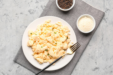 Composition with plate of scrambled eggs on grunge background