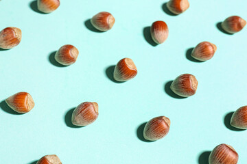 Shelled hazelnuts on blue background, closeup