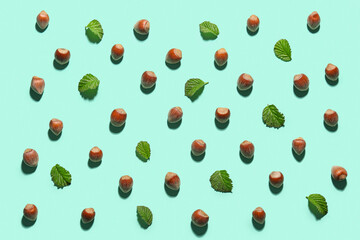 Shelled hazelnuts with leaves on blue background, closeup