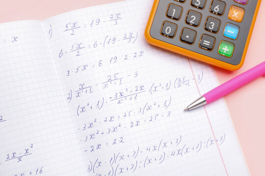 Copybook with maths formulas, pen and calculator on pink background - Powered by Adobe