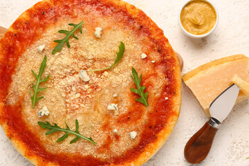 Wooden board of tasty pizza with parmesan cheese and knife on light background