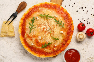 Wooden board of tasty pizza with parmesan cheese and tomato sauce on light background